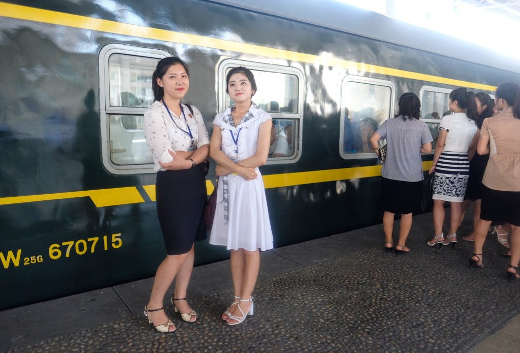 Two North Korean Tour guides at Pyongyang train station after a north korea tour