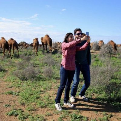 Tourists posing with camels on our Turkmenistan tours